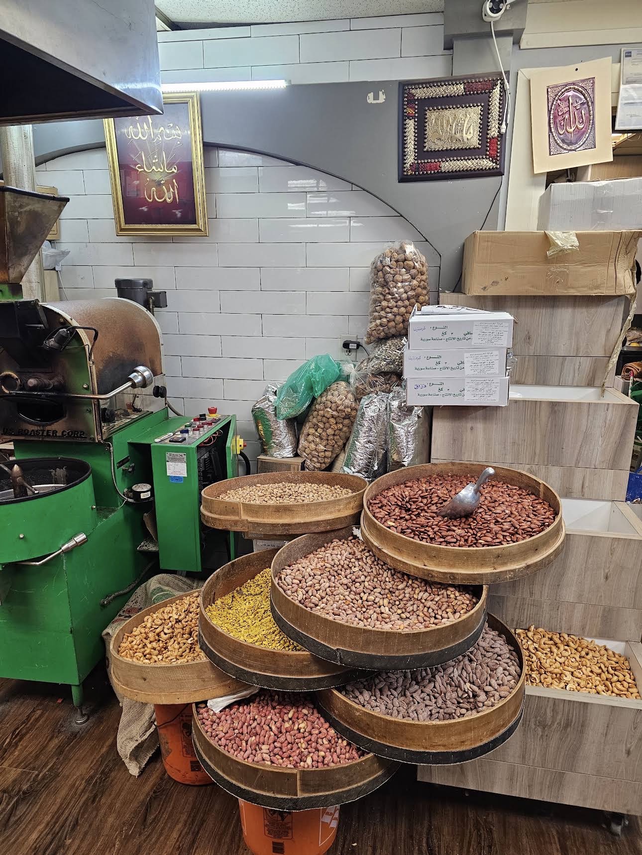 Wooden bins of freshly roasted nuts beside our in-house roaster